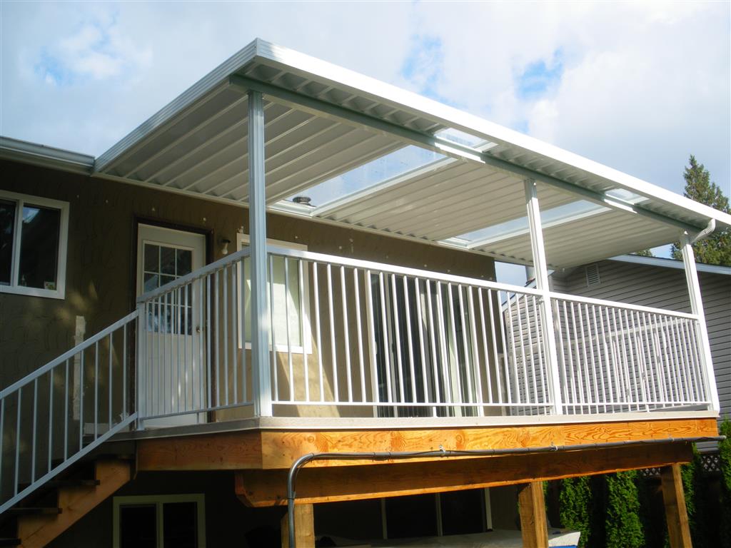 Aluminum canopy with skylights with white panels, white trim, and whtie posts.