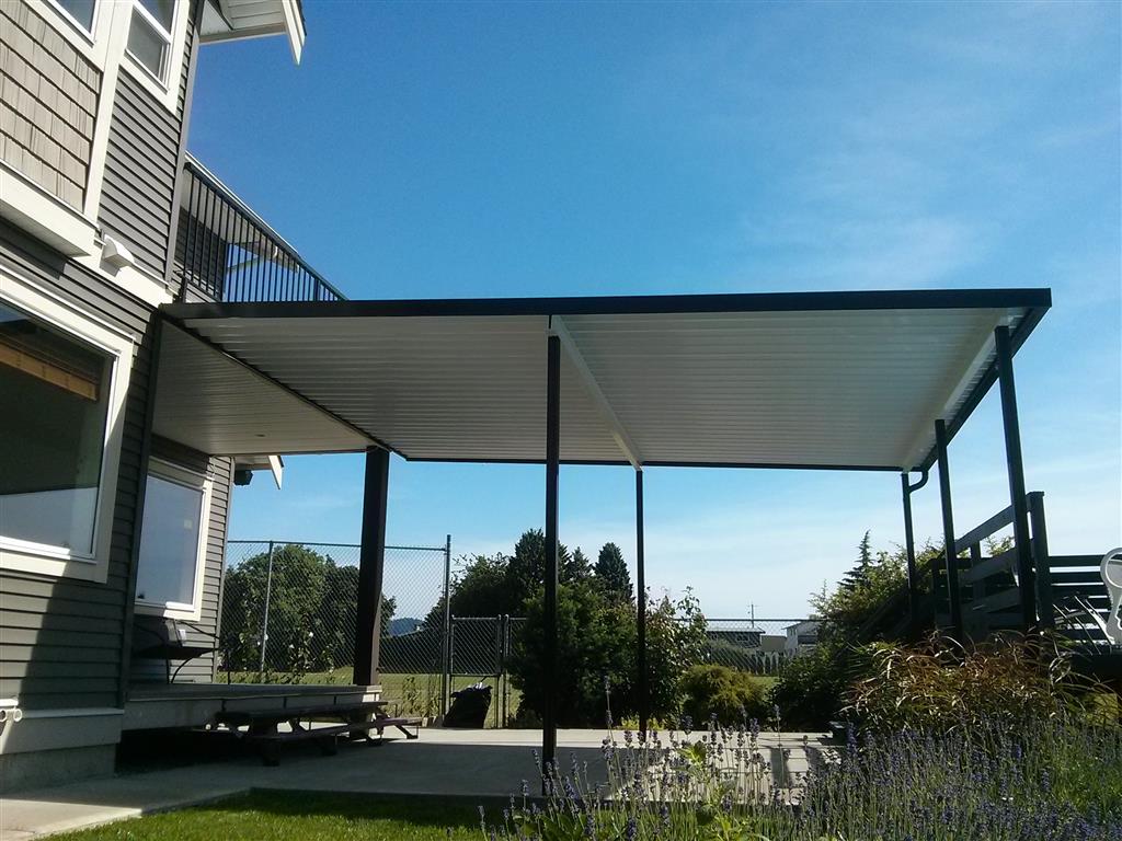 Aluminum canopy no skylights with black trim and white panels.