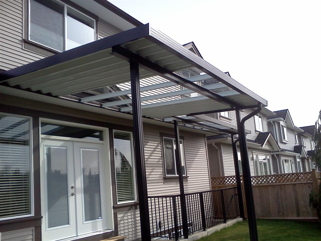 Aluminum canopy with skylights with white panels, black trim, and black posts.