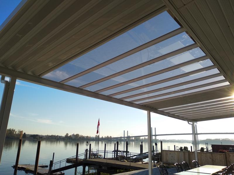 Aluminum canopy with skylights with white panels, white trim, and white posts.