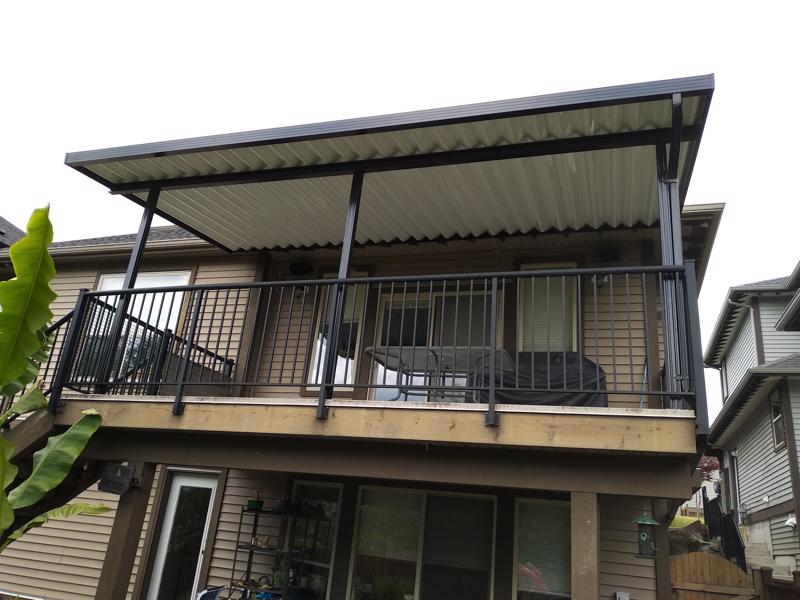 Aluminum canopy with white panels, black trim, and black posts.